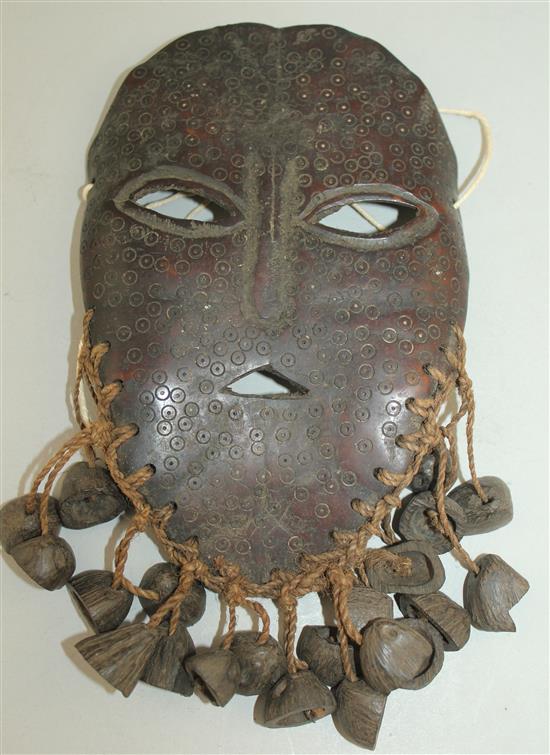 A tribal carved bone mask, 8.5in.